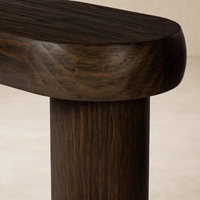 Detail of the Maelle Console Table showcasing its smooth, rounded edges and rich wood grain finish.