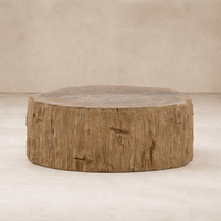 Rustic round Arik Coffee Table crafted from textured wood, showcasing its natural finish and unique design.