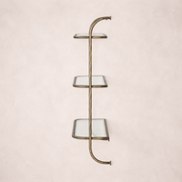 Side view of the Winslow Shelf featuring four glass shelves with a sleek brass frame.