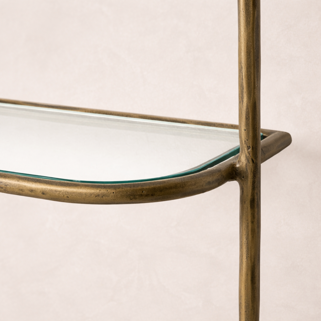 Detail of the Winslow Shelf featuring a sleek glass surface and a stylish brass frame.