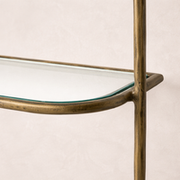 Detail of the Winslow Shelf featuring a sleek glass surface and a stylish brass frame.
