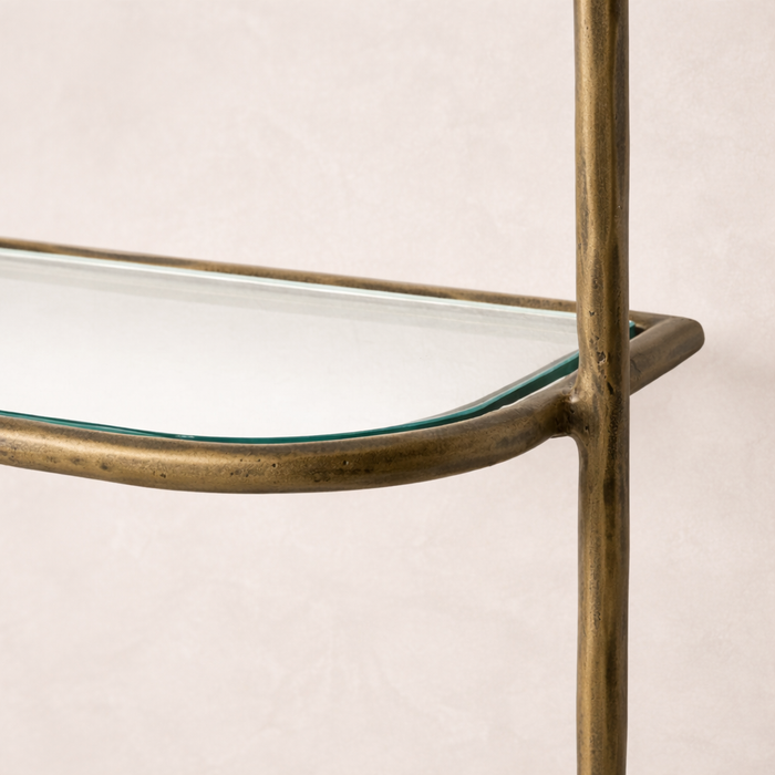 Detail of the Winslow Shelf featuring a sleek glass surface and a stylish brass frame.