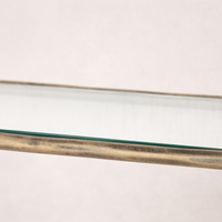 Close-up of the Winslow Shelf showcasing its sleek glass surface and rustic metal frame.