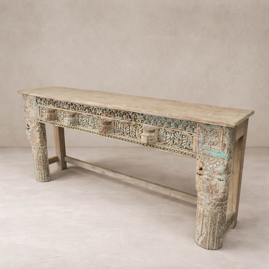 Three-quarter view of the Adana Carved Vintage Console Table showcasing intricate detailing and a weathered finish.