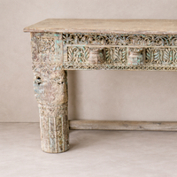 Detail of the Adana Carved Vintage Console Table showcasing intricate carvings and a weathered finish.