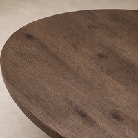 Close-up of the Juniper Coffee Table showcasing its rich, textured wood finish and round surface.