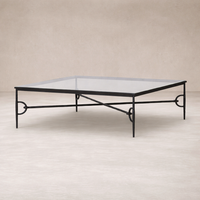Side angle of the Selene Coffee Table featuring a sleek glass top and elegant black metal frame.