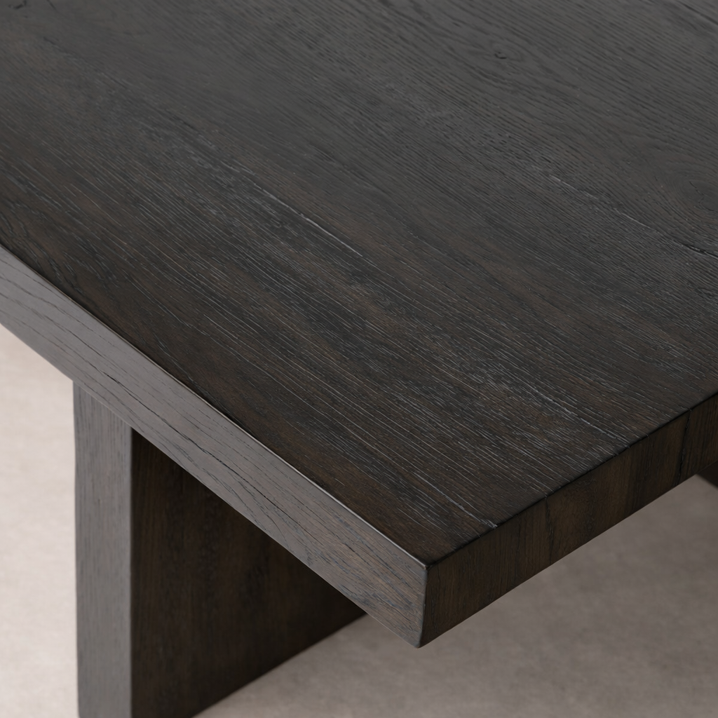 Detail of the Arles Coffee Table highlighting its rich, dark wood grain and minimalist design.