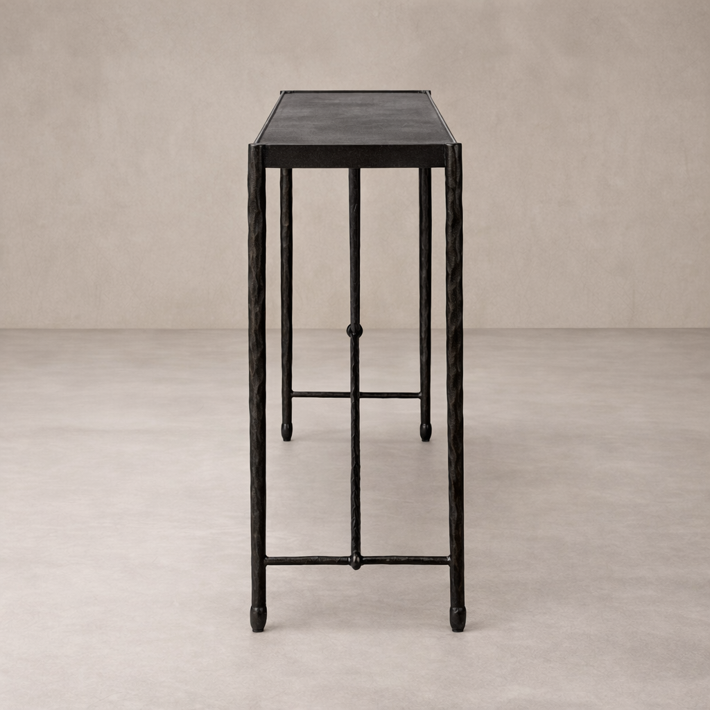 Side view of the Blythe Console Table showcasing its sleek black finish and elegant, textured legs.