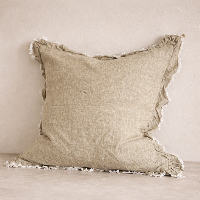 Close-up of the Hallie Ruffled Linen Pillow in Washed Olive, highlighting its textured fabric and frayed edges.