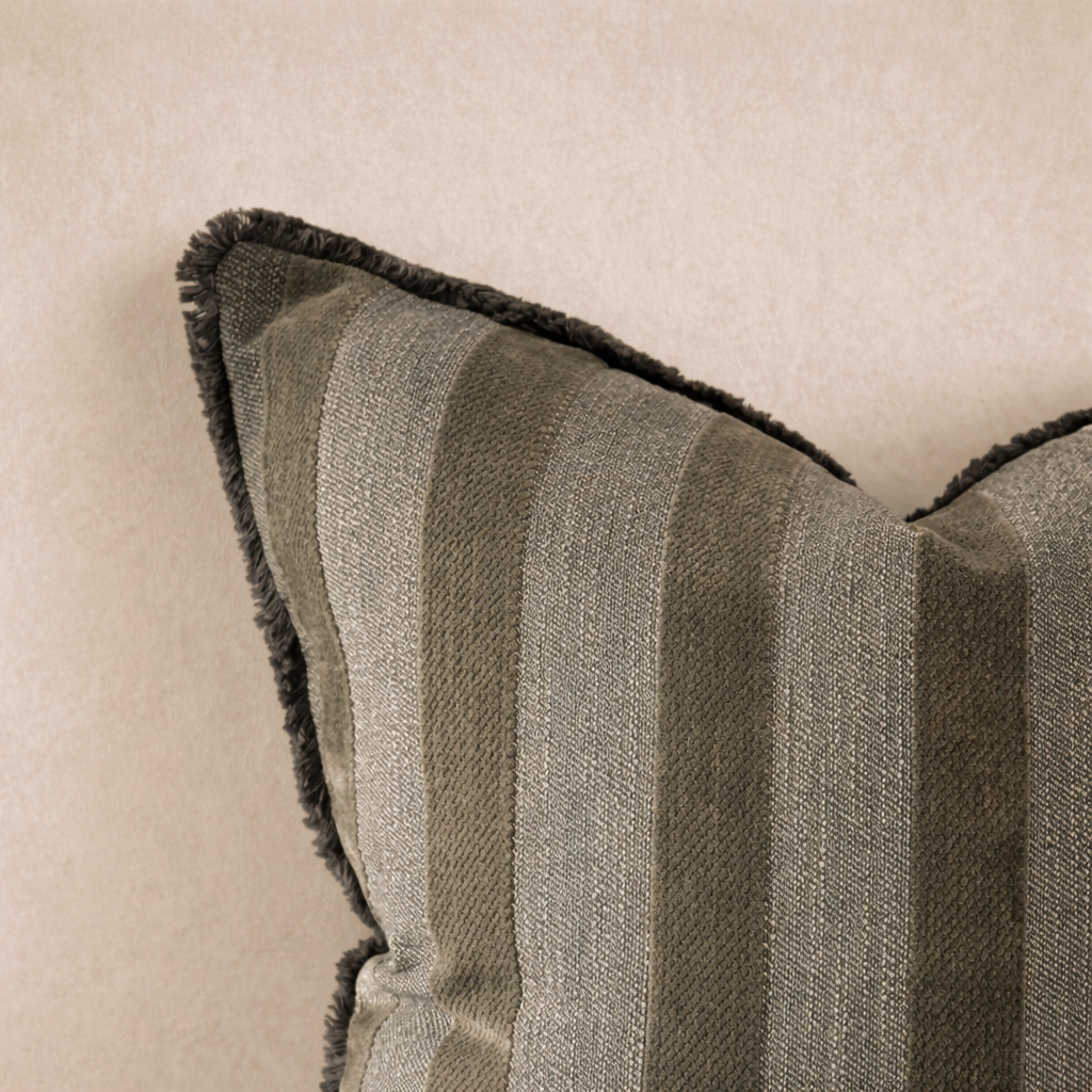 Close-up of the Isla Striped Pillow in Olive, featuring textured stripes and a plush fringe trim.