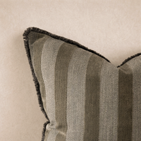 Close-up of the Isla Striped Pillow in Olive, featuring textured stripes and a plush fringe trim.