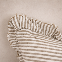 Detail of the Hallie Ruffled Linen Pillow in Olive Stripes, highlighting its textured ruffled edge and soft fabric.