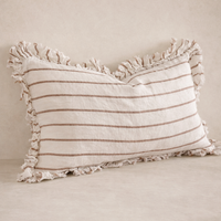Close-up of the Hallie Ruffled Linen Pillow in brown and cream stripes, featuring a textured fringe edge.