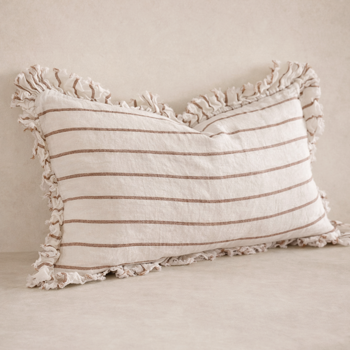 Close-up of the Hallie Ruffled Linen Pillow in brown and cream stripes, featuring a textured fringe edge.
