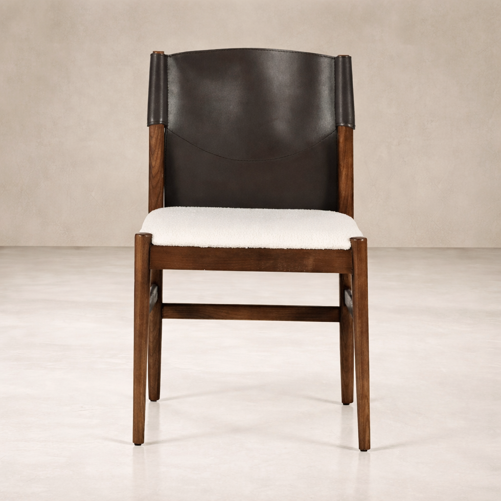 Front view of the Calais Dining Chair featuring a sleek leather backrest and plush seat.
