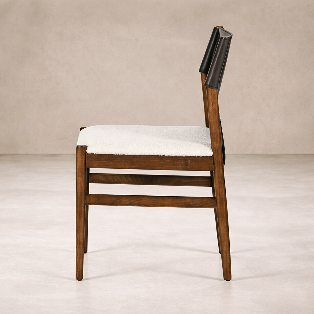 Side angle of the Calais Dining Chair, showcasing its warm wood finish and plush seat upholstery.