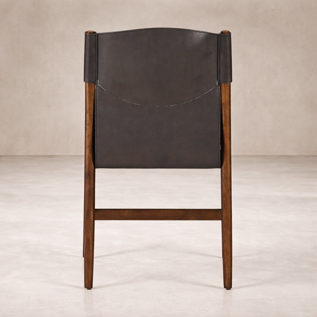 Back view of the Calais Dining Chair showcasing its dark leather seat and warm wooden frame.