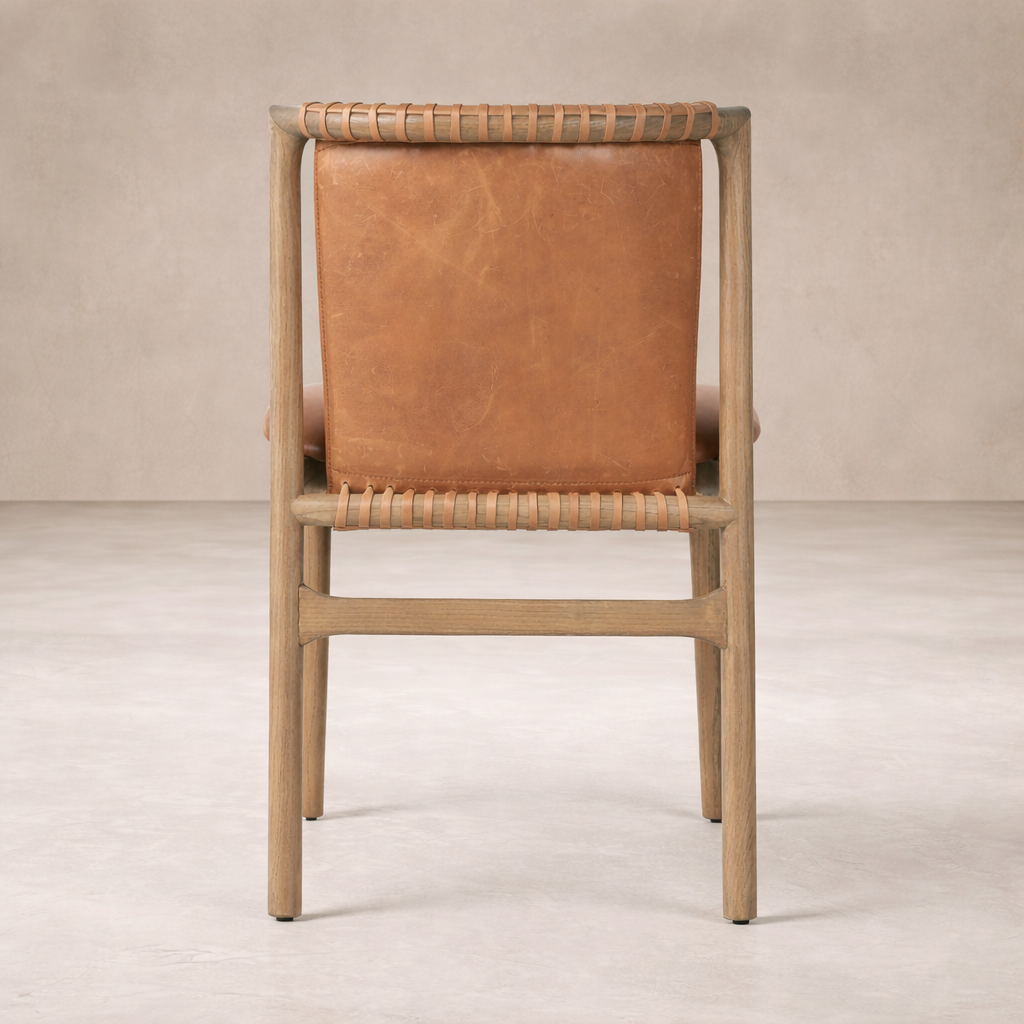 Back view of the Marbella Dining Chair featuring a rich leather seat and woven detailing.