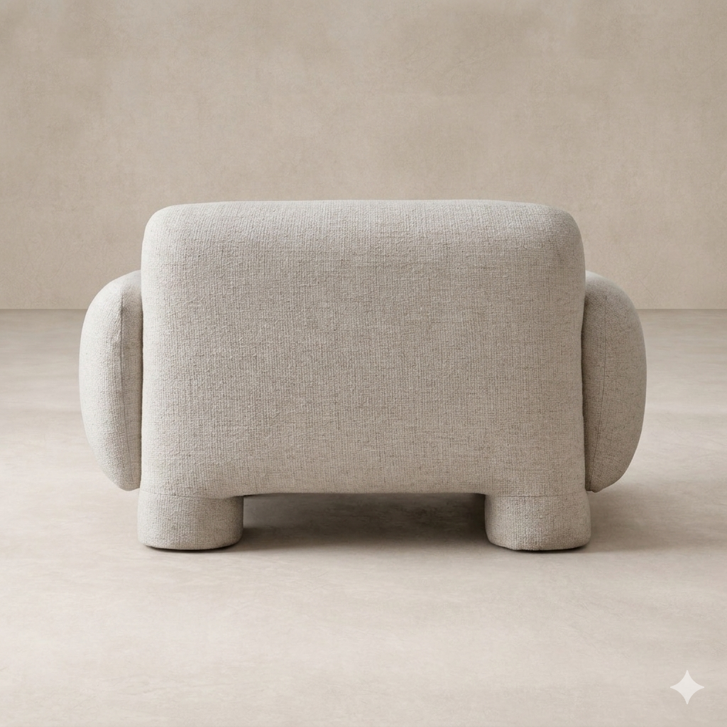 Back view of the Elba Accent Chair showcasing its rounded, plush design and soft fabric texture.