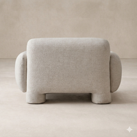 Back view of the Elba Accent Chair showcasing its rounded, plush design and soft fabric texture.