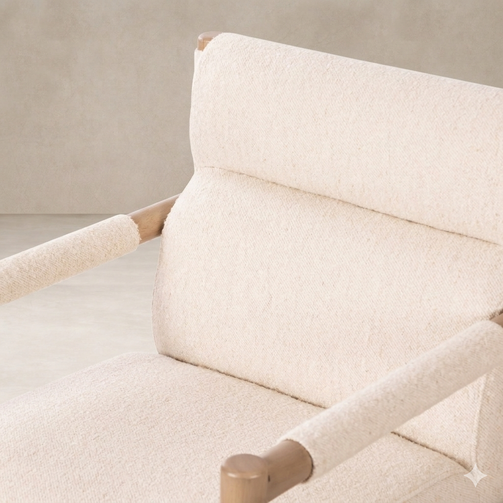 Detail of the Sorrento Dining Chair showcasing its soft, textured upholstery and natural wood armrests.