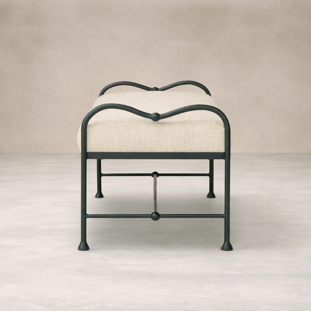 Front view of the Rune Accent Bench featuring a curved metal frame and soft beige upholstery.