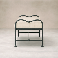 Front view of the Rune Accent Bench featuring a curved metal frame and soft beige upholstery.