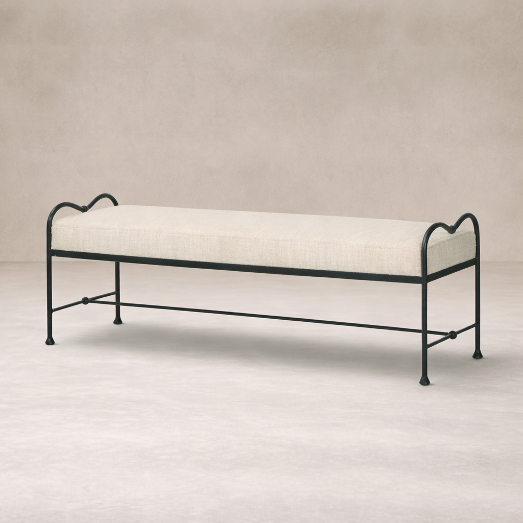 Side angle of the Rune Accent Bench featuring a soft upholstered seat and elegant black metal frame.