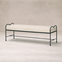 Side angle of the Rune Accent Bench featuring a soft upholstered seat and elegant black metal frame.