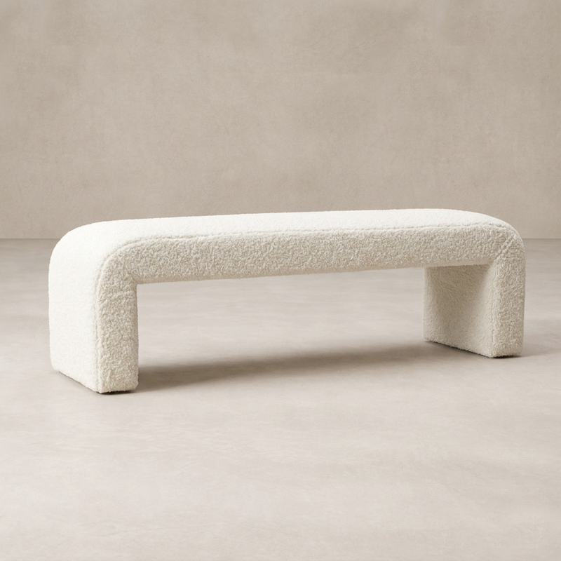Front view of the Kenneth Bench in soft, textured white upholstery, featuring rounded edges and sturdy legs.