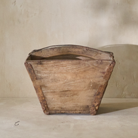 Front view of a vintage 19th-century rice bucket, showcasing its rustic wooden construction and unique shape.