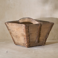 Side angle of a vintage 19th-century rice bucket, showcasing its rustic wooden construction and unique shape.