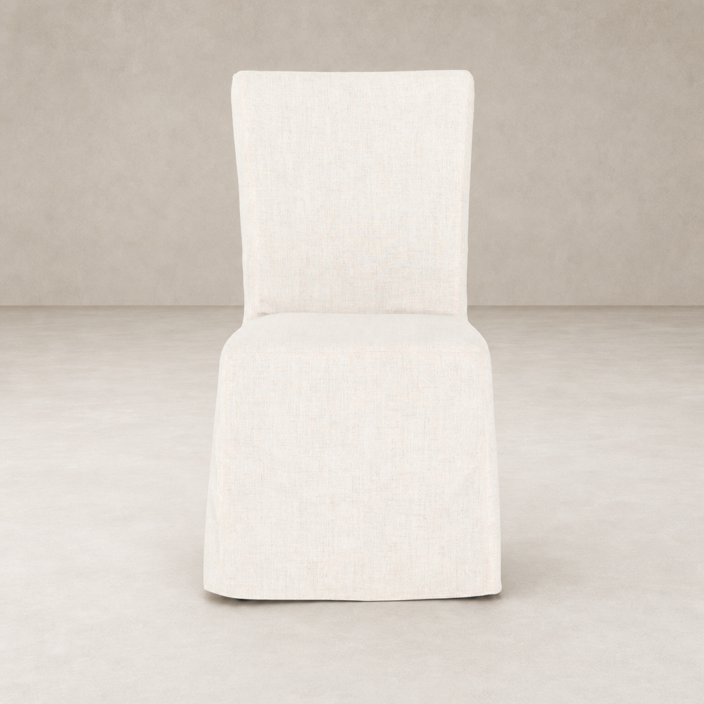 Sierra Slipcovered Dining Chair featuring a light, textured fabric in a minimalist design.