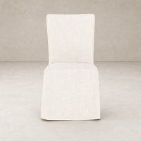 Sierra Slipcovered Dining Chair featuring a light, textured fabric in a minimalist design.
