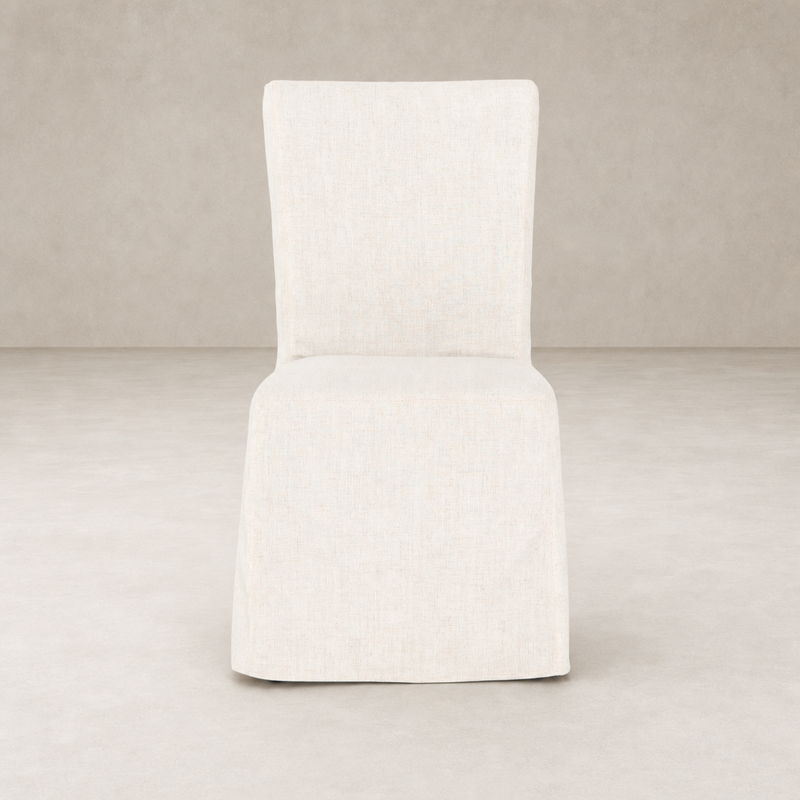 Sierra Slipcovered Dining Chair featuring a light, textured fabric in a minimalist design.
