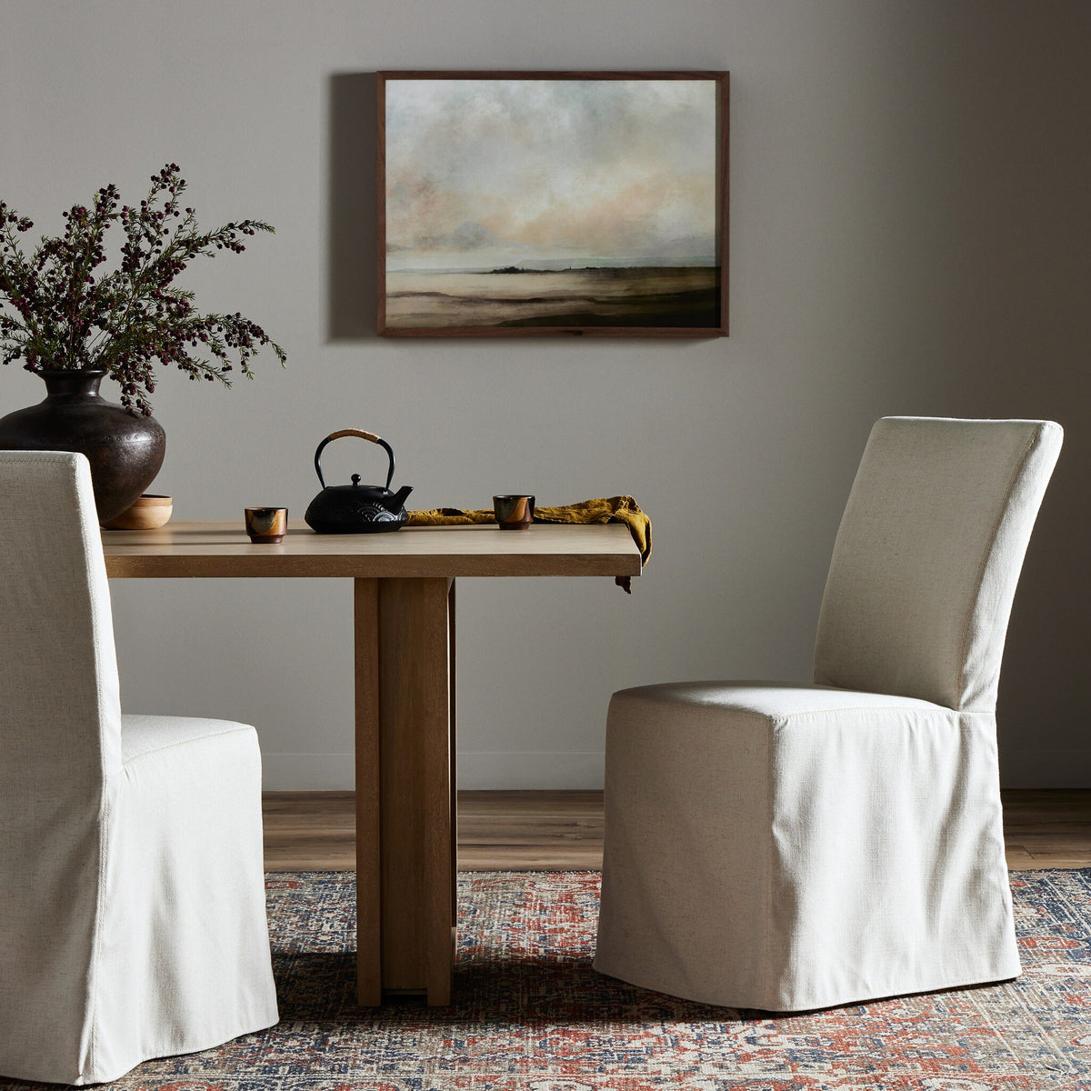 Sierra Slipcovered Dining Chair with a soft, light fabric in a cozy dining setting.