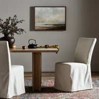 Sierra Slipcovered Dining Chair with a soft, light fabric in a cozy dining setting.