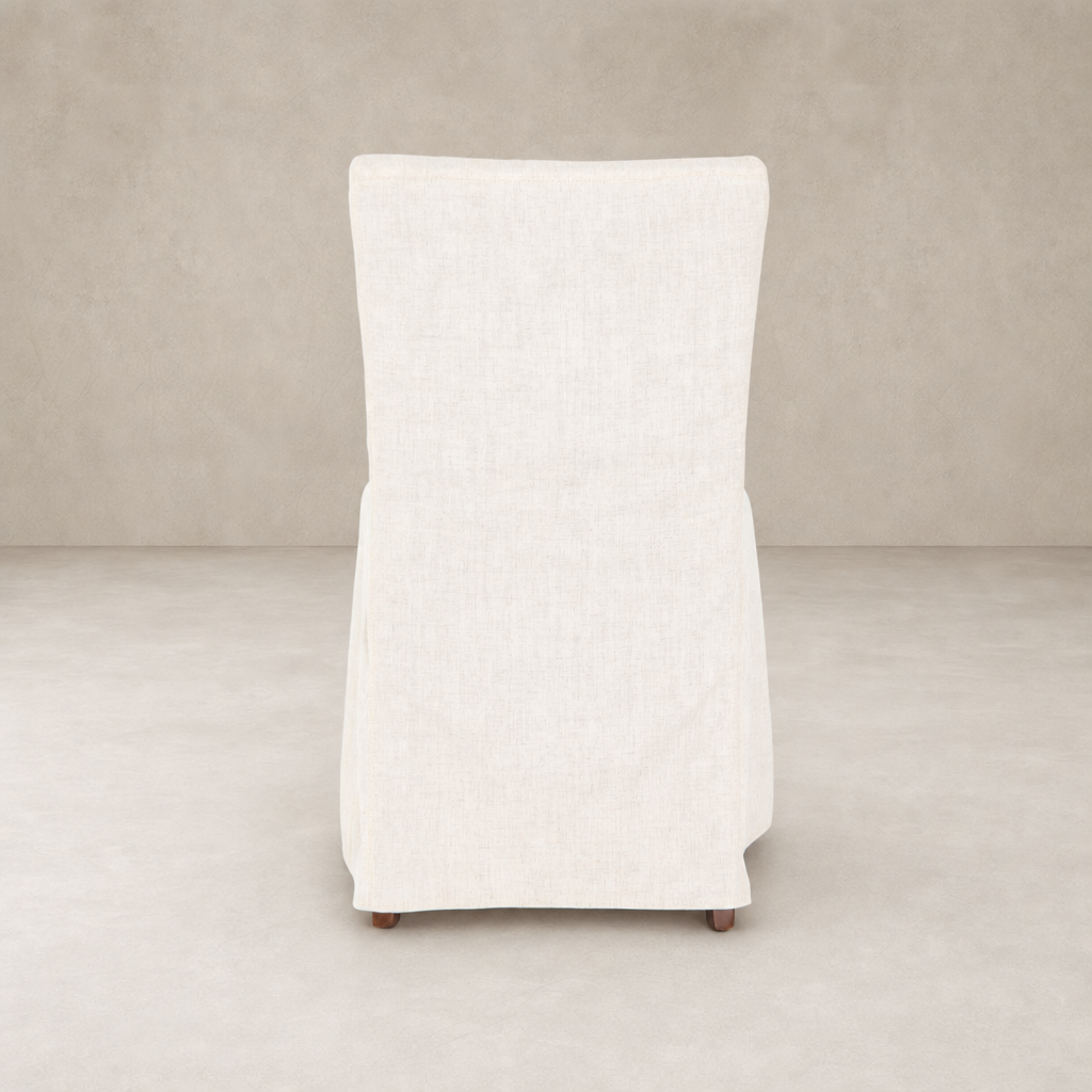Sierra Slipcovered Dining Chair in soft white with tailored slipcover and natural wood legs.