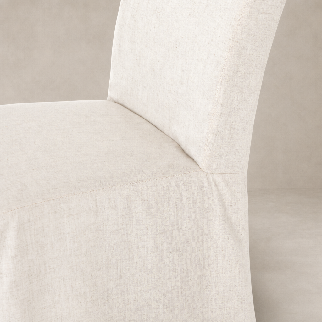 Sierra Slipcovered Dining Chair featuring a textured, light-colored fabric and clean design.