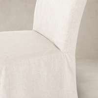Sierra Slipcovered Dining Chair featuring a textured, light-colored fabric and clean design.