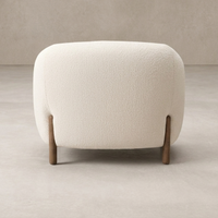 Back view of the Laurel Accent Chair featuring a textured cream upholstery and wooden legs.