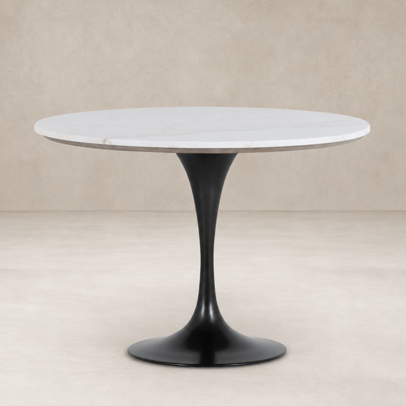 Modena Dining Table features a round white marble top and sleek black base.
