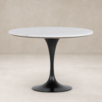 Modena Dining Table features a round white marble top and sleek black base.
