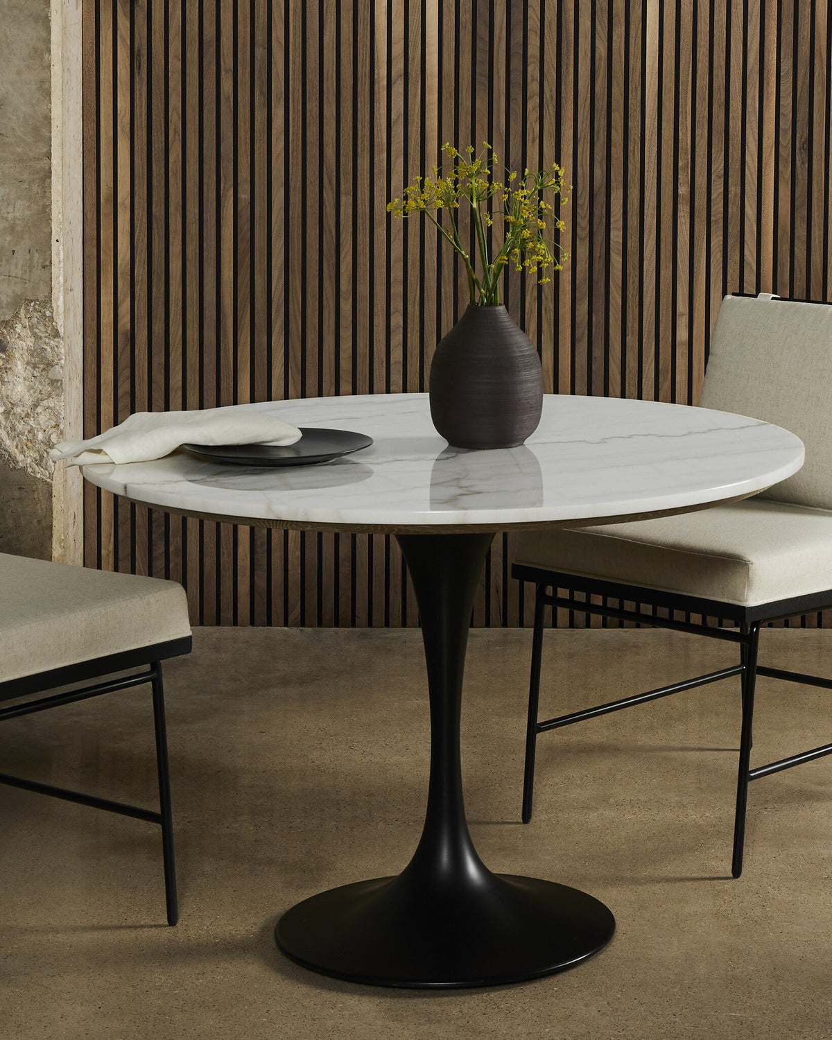 Modena Dining Table with a sleek white marble top and black pedestal base.