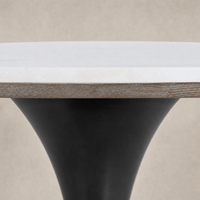 Modena Dining Table featuring a sleek white marble top with a tapered black base.