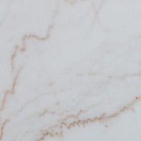 Detailed close-up of the white marble finish of the Modena Dining Table.