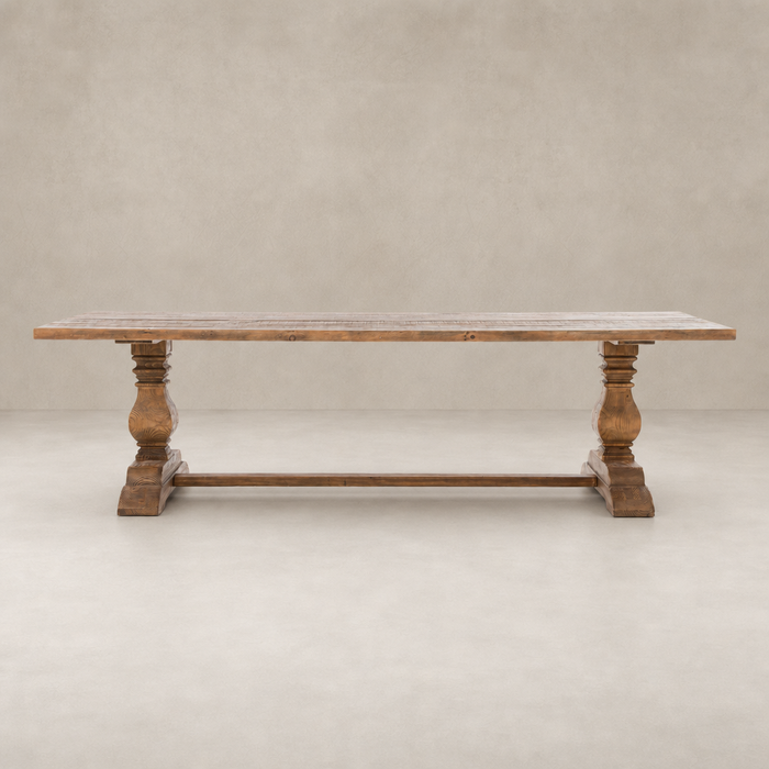 Castelli Dining Table in waxed bleached reclaimed pine with ornate turned legs.