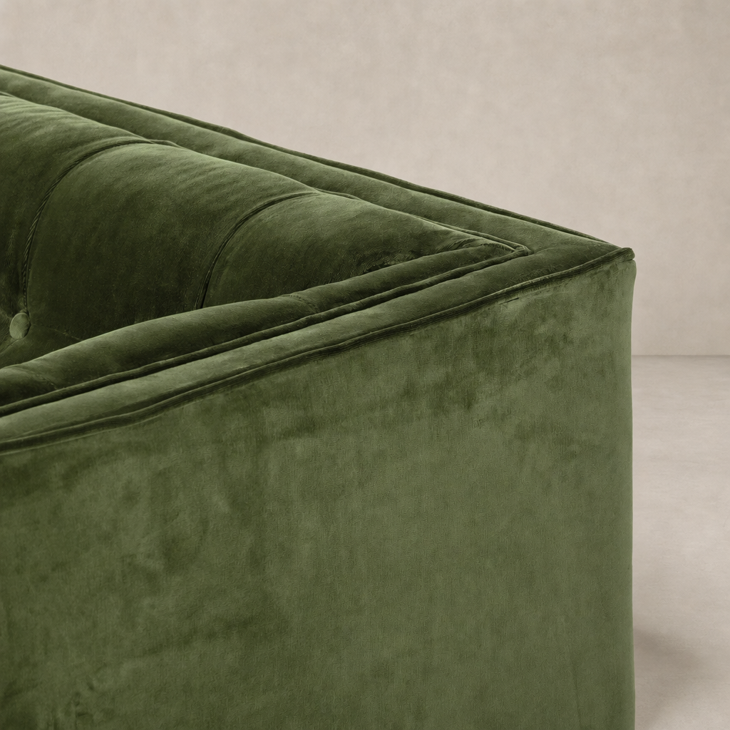 Murano Chair in sapphire olive, showcasing soft tufted upholstery and sleek contours.