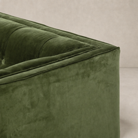 Murano Chair in sapphire olive, showcasing soft tufted upholstery and sleek contours.
